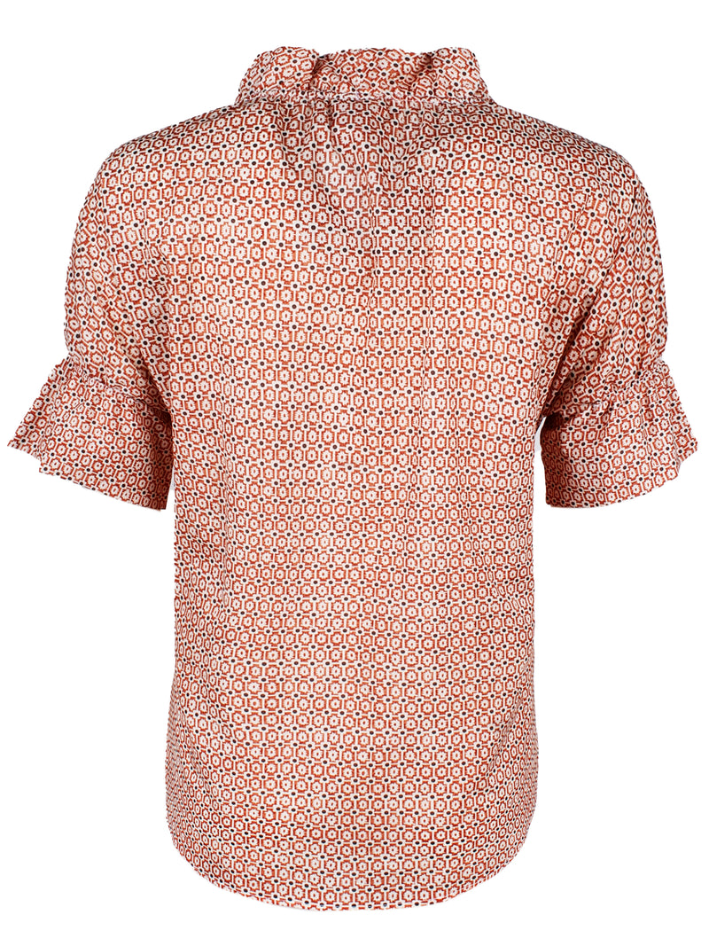 A rear view of Finley Crosby, a short sleeve womens blouse with ruffle collar and sleeve details and a geometric orange pattern.