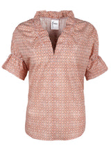 A front view of Finley Crosby, a short sleeve womens blouse with ruffle collar and sleeve details and a geometric orange pattern.