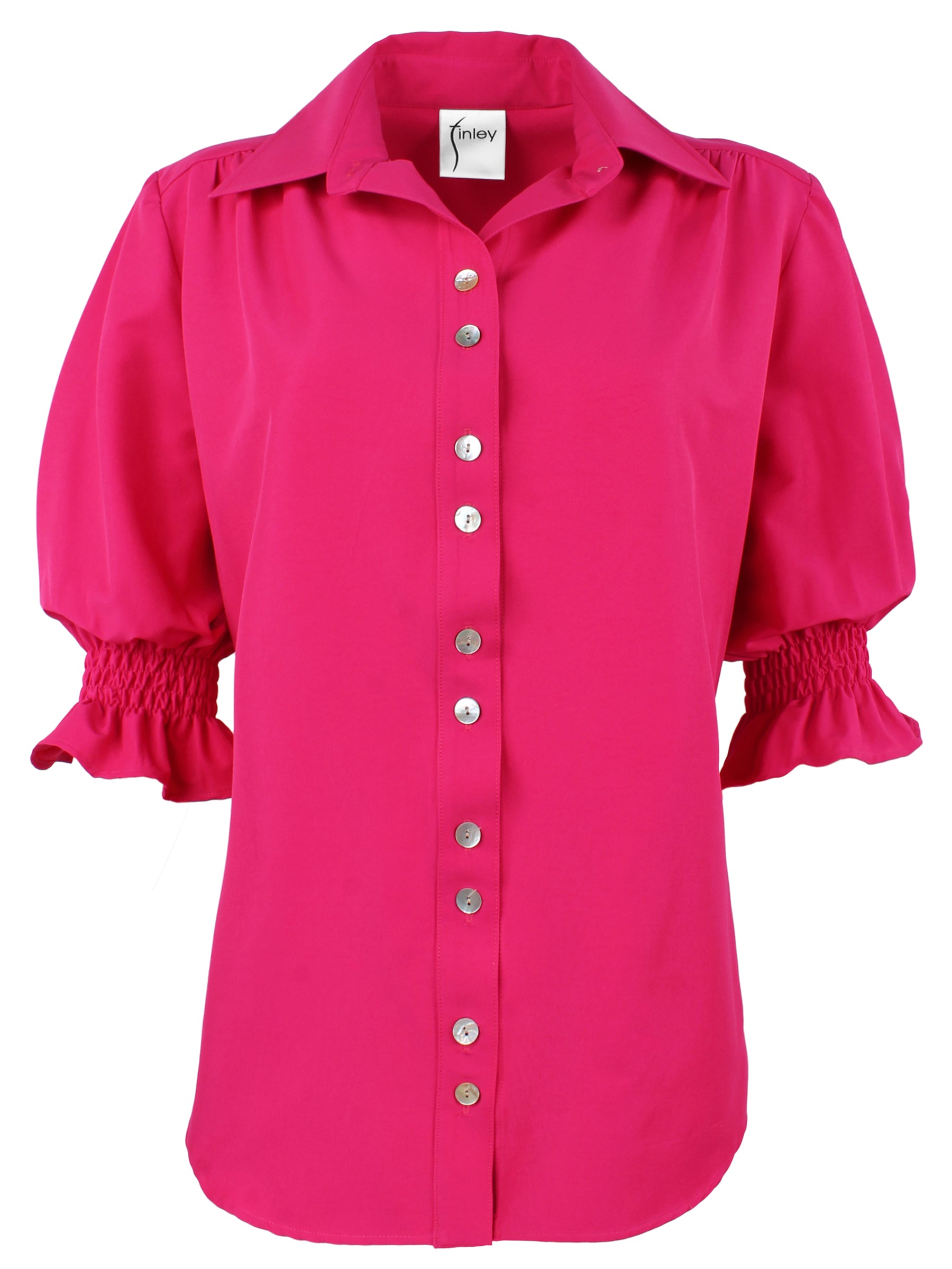 A front view of the Sirena shirt in vibrant fuschia, showcasing puff sleeves and shirred accents.
