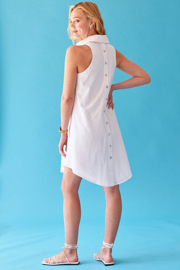 A model wearing the Finley swing dress, a sleeveless button down midi shirt dress with an a-line silhouette and a white eyelet stripe.