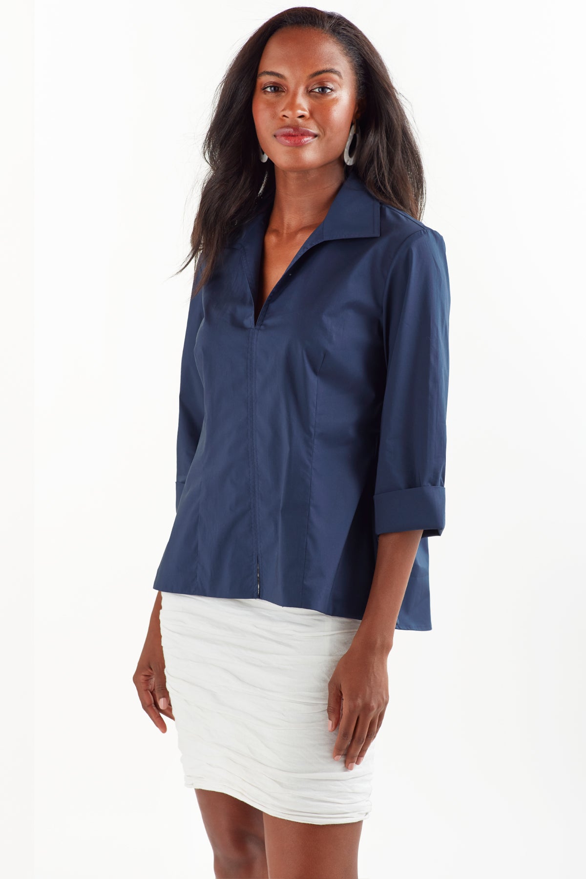 A model wears the Finley swing shirt, a 3/4 sleeve navy v-neck popover with a relaxed shape and a back inverted pleat.