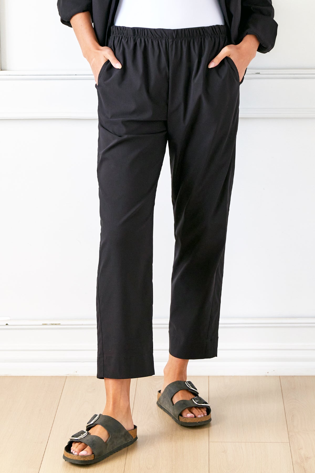 a model view of the Travel pant, featuring a super stretch viscose blend with an elastic waist and side pockets
