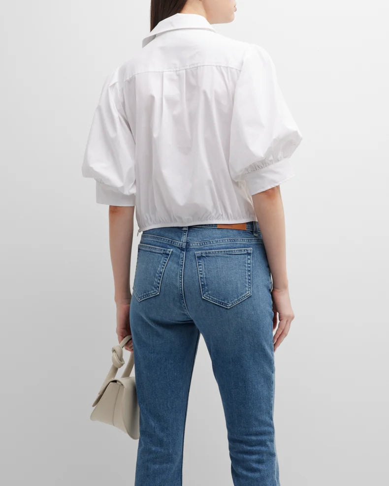 The Finley Bomba blouse, a casual white designer blouse with short puff sleeves and a relaxed fit.