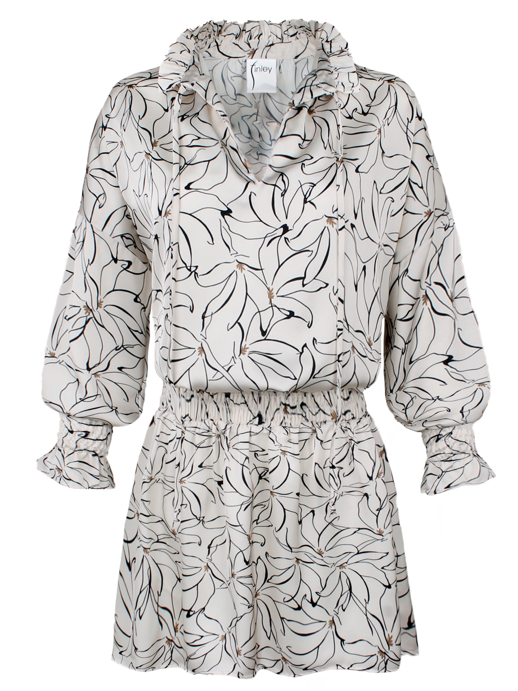 A front view of the Elizabeth shirt dress, featuring a tie-front, smocked details, white and black floral pattern, a blouson bodice, and a split neckline.