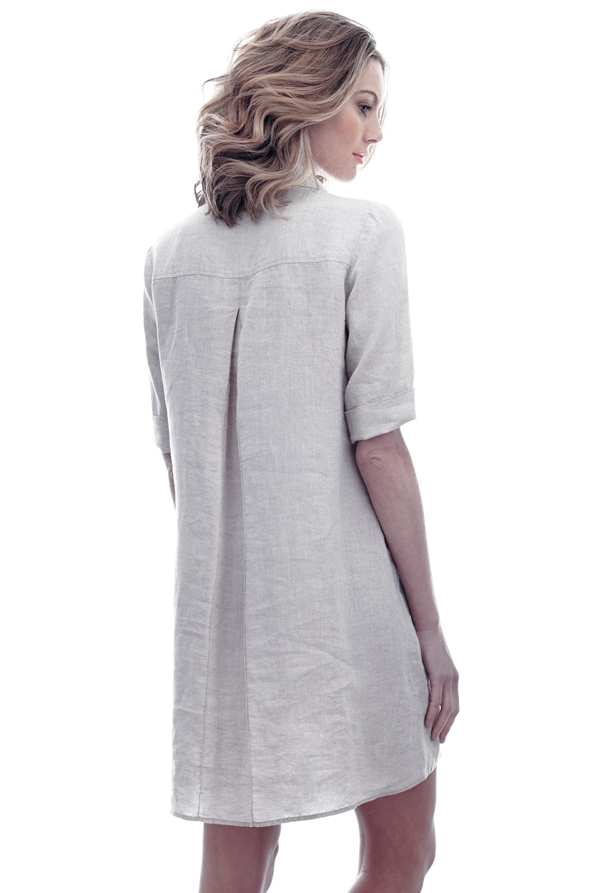 A model wearing Finley Marcia dress, a natural gray washed linen short-sleeve v-neck shirt dress.