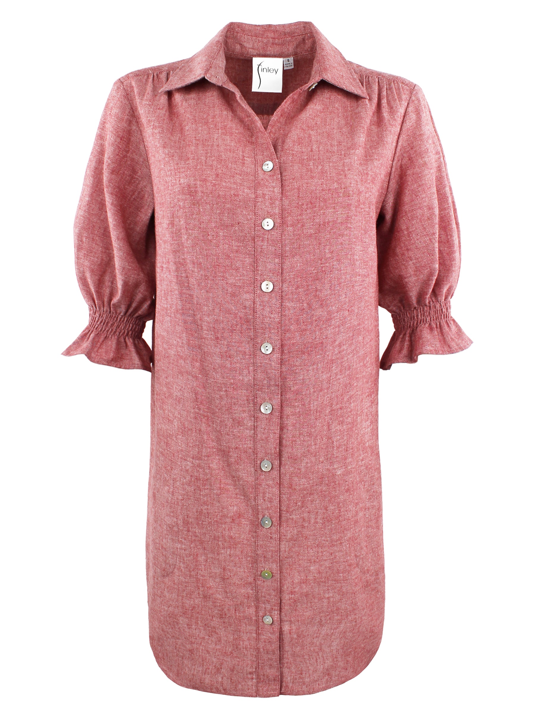 A front view of the Miller shirt dress, made from a hemp cotton blend in pale tomato red with elbow-length puff sleeves, chambray fabric, and pockets.
