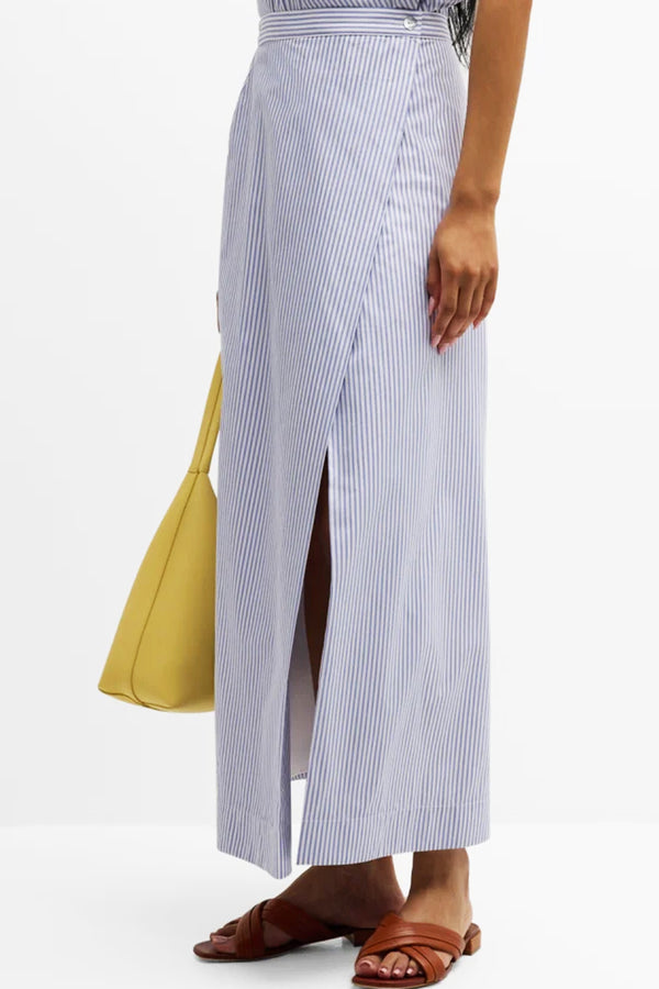 A model wearing the Finley slit hem maxi wrap skirt, a womens cotton skirt with a straight silhouette and a button closure.